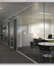 Drei moderne Bürobereiche mit Glastrennwänden und minimalistischer Einrichtung.