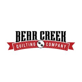 "Bear Creek Quilting Company logo with a red ribbon and bear paw design."