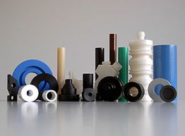 Mehrfarbige Kunststoffteile in verschiedenen Formen und Größen vor neutralem Hintergrund.