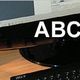 Computerarbeitsplatz mit Text: ABC-Seminare, Webservice, SEO, PC-Kurse.