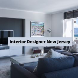 Modern living room with a gray sofa, TV, and artwork, text overlay: "Interior Designer New Jersey".