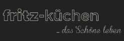 Textlogo: "fritz-küchen - das schöne leben" auf dunklem Hintergrund.