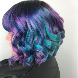 Shoulder-length hair with vibrant purple, blue, and teal curls.