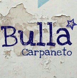Scritta "Bulla Carpaneto" su sfondo bianco scrostato con una stella blu accanto alla "a".