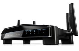 Black wireless router with multiple antennas and LED indicators.