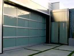 Modern house with a glass-paneled garage door and sleek entrance.