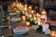 Elegant table setting with candles, flowers, and neatly arranged place settings.