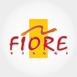 Logo con scritta "FIORE VIAGGI" in rosso su sfondo giallo con dettaglio arancione sopra.