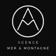 Logo de l'Agence Mer & Montagne : un A stylisé dans un cercle sur fond noir.