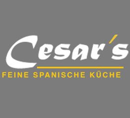 Graues Logo mit Text: "Cesar's - Feine Spanische Küche" in Weiß und Gelb.