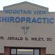 Building sign for Mountain View Chiropractic with doctor's name and chiropractic symbol.
