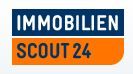Logo mit der Aufschrift "Immobilien Scout24" in Blau und Orange.