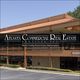 Two-story commercial building with sign for Atlanta Commercial Real Estate Services.