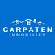 Logo von "Carpaten Immobilien" auf blauem Hintergrund mit stilisiertem Haus und Bergen.