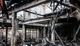 Charred remains of a burned-down building with damaged beams and debris inside.