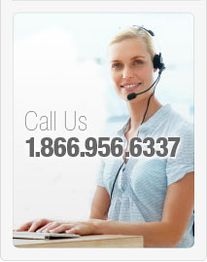 Woman with headset sitting at a desk, call us at 1.866.956.6337.