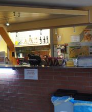 Verkaufstresen mit Getränken, Snacks und Informationsmaterialien. Mülleimer im Vordergrund.