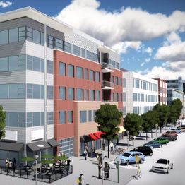 Street view of modern buildings, pedestrians, and parked cars on a sunny day.