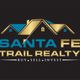 Gold and blue Santa Fe Trail Realty logo with roof design, text: "Buy. Sell. Invest."