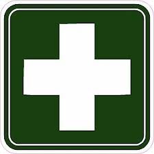Grünes Schild mit weißem Kreuz, Symbol für Erste Hilfe oder Apotheke.