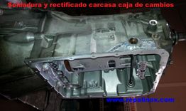 Caja de cambios de automóvil con texto "Soldadura y rectificado carcasa caja de cambios".