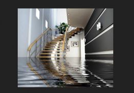 Modern staircase in a flooded hallway with water reflecting ceiling lights.