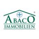 Logo von Abaco Immobilien, blauer Stern über grünem Text in Hausform.