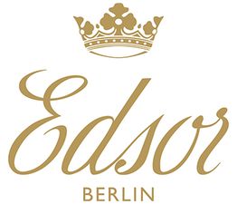 Logo mit Krone und Schriftzug "Edsor Berlin" in goldener Farbe.
