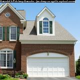 Brick house with a double garage and a dormer window above.