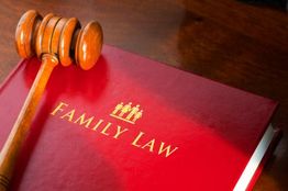 Gavel resting on a red "Family Law" book on a wooden surface.