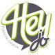 Logo avec le texte "Hey jo" en lettres vertes et grises, "Publicité créative" en italique.