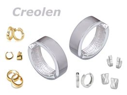Verschiedene Creolen in Gold und Silber auf weißem Hintergrund.
