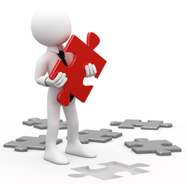 Muñeco blanco con pieza roja de rompecabezas, de pie entre piezas grises esparcidas.