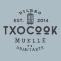 Logotipo de Txocook con texto "Bilbao, Est. 2014, Muelle nº1 Uribitarte" en fondo azul claro.