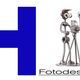 Buchstabe H mit Schriftzug "Hartmann Fotodesign" und einer Metallfigur mit Kamera und Blitz.