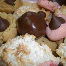 Assorted cookies with chocolate and coconut toppings on display.