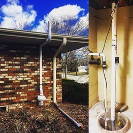 House with external and internal sump pump system and piping against a brick wall.