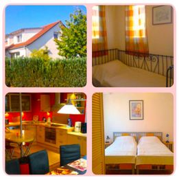 Haus mit Garten, Essbereich in roter Küche, Einzelbett in gemütlichem Raum, Doppelbett im Schlafzimmer.