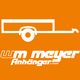 Logo von WM Meyer Anhänger auf orangefarbenem Hintergrund.