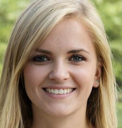 Smiling person with long blonde hair and green blurred background.