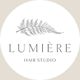 Logo of Lumière Hair Studio featuring a fern leaf above the text.