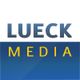 Logo mit dem Text "Lueck Media" in blauer und gelber Schrift auf weißem und blauem Hintergrund.