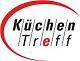 Logo mit schwarzem Text "KüchenTreff" in Kreis mit rotem Rand.