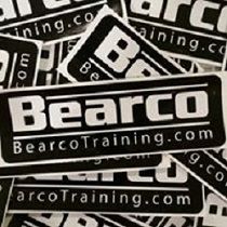 "Black and white BearcoTraining.com stickers in a scattered pile."