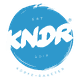 Blaues Logo mit weißem "KNDR" Text, darunter "Köpfe + Raketen", etabliert 2013.