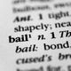 Close-up of the word "bail" with its definition in a dictionary.
