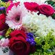 A colorful bouquet with roses, hydrangeas, gerbera daisies, and assorted small flowers.