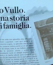 Testo di una storia di famiglia "Lo Vullo", con immagine di negozio ottico storico a destra.