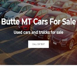 Used cars parked in a lot with a sign "Butte MT Cars For Sale."