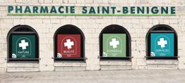 Façade de la Pharmacie Saint-Benigne avec affiches de nature, beauté, conseils et services.